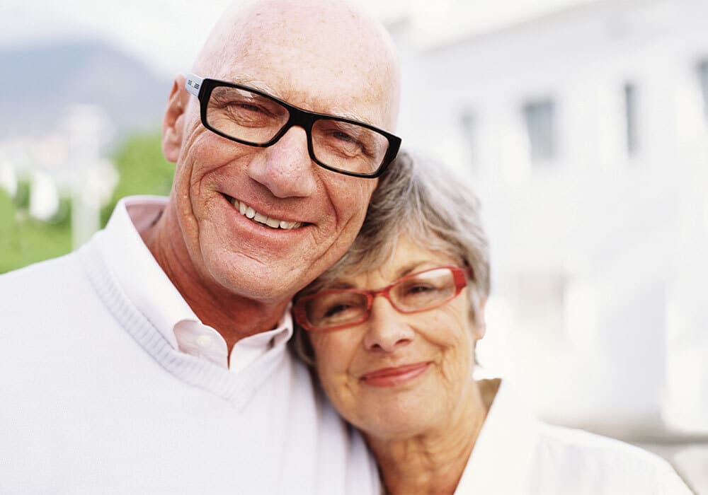 Mature woman leaning into man both with glasses